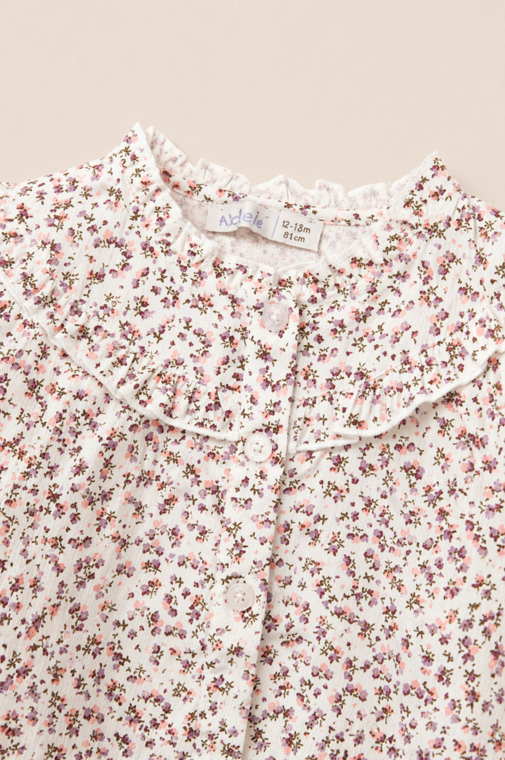 Blouse bébé fleurie à col volant – Raffinement & douceur